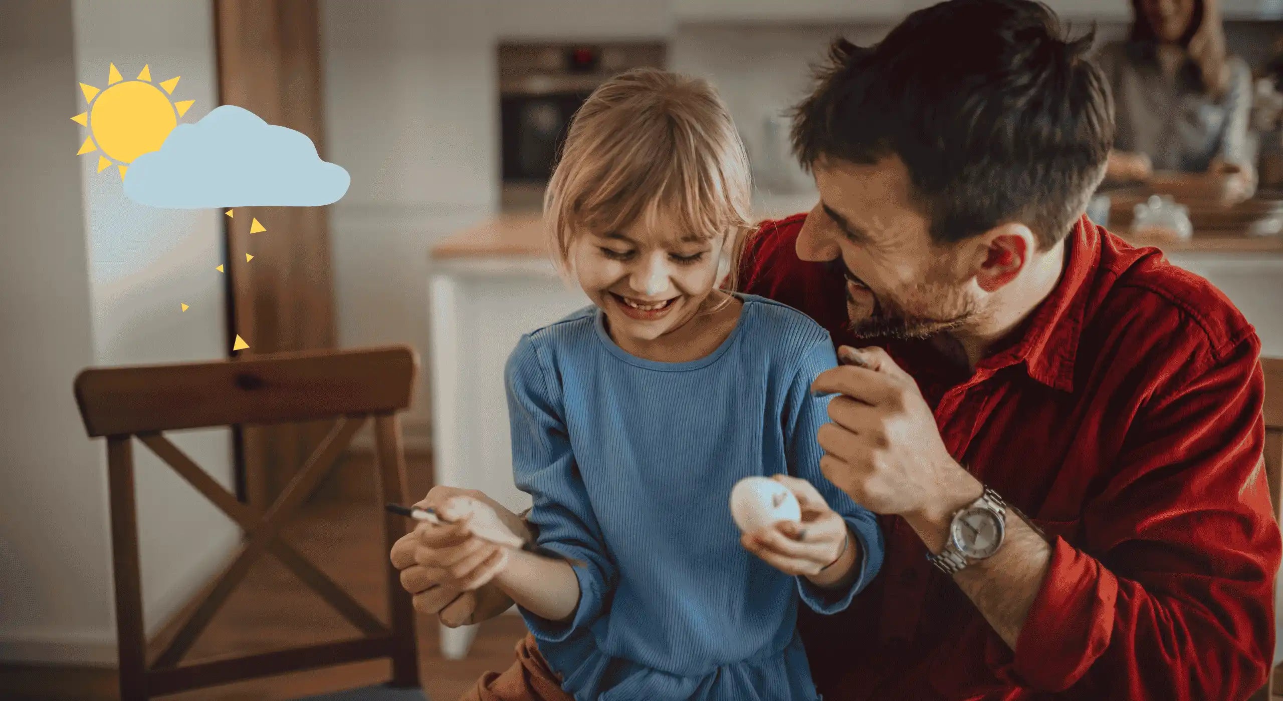 Mädchen malt mit Papa Ostereier an