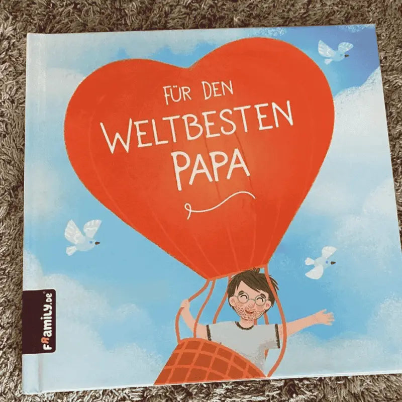 Das Framily-Buchcover "Für den weltbesten Papa" zeigt einen Jungen in einem roten herzförmigen Heißluftballon mit weißen Vögeln und ist damit ein einzigartiges, personalisiertes Geschenk für Papa.